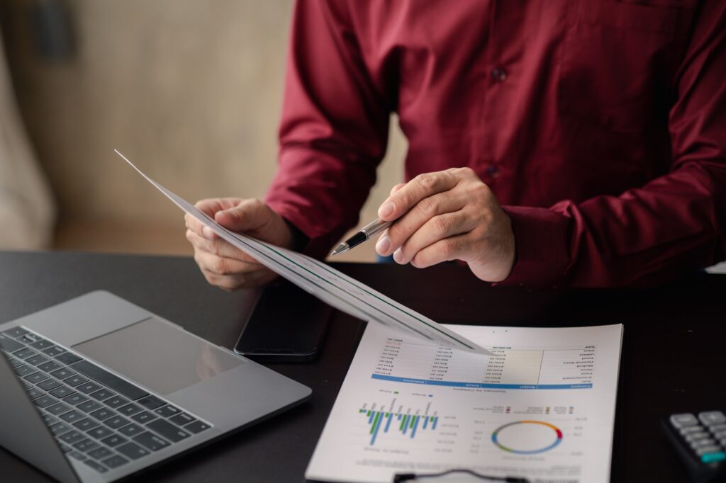 Business men are looking at the company's financial documents to analyze problems and find solutions