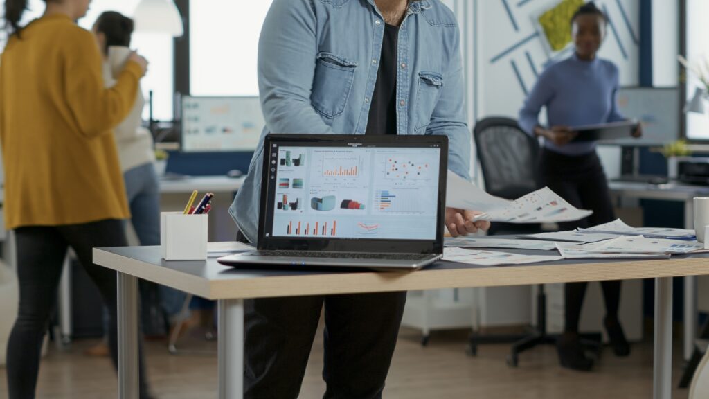 Closeup of laptop screen with enterprise resource planning showing moving charts and growing